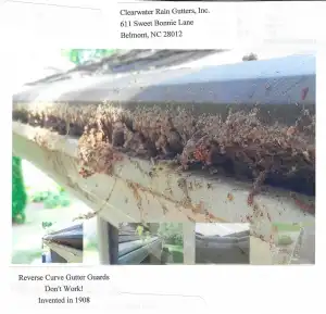 Close-up of a house gutter clogged with debris, despite having a gutter guard installed.